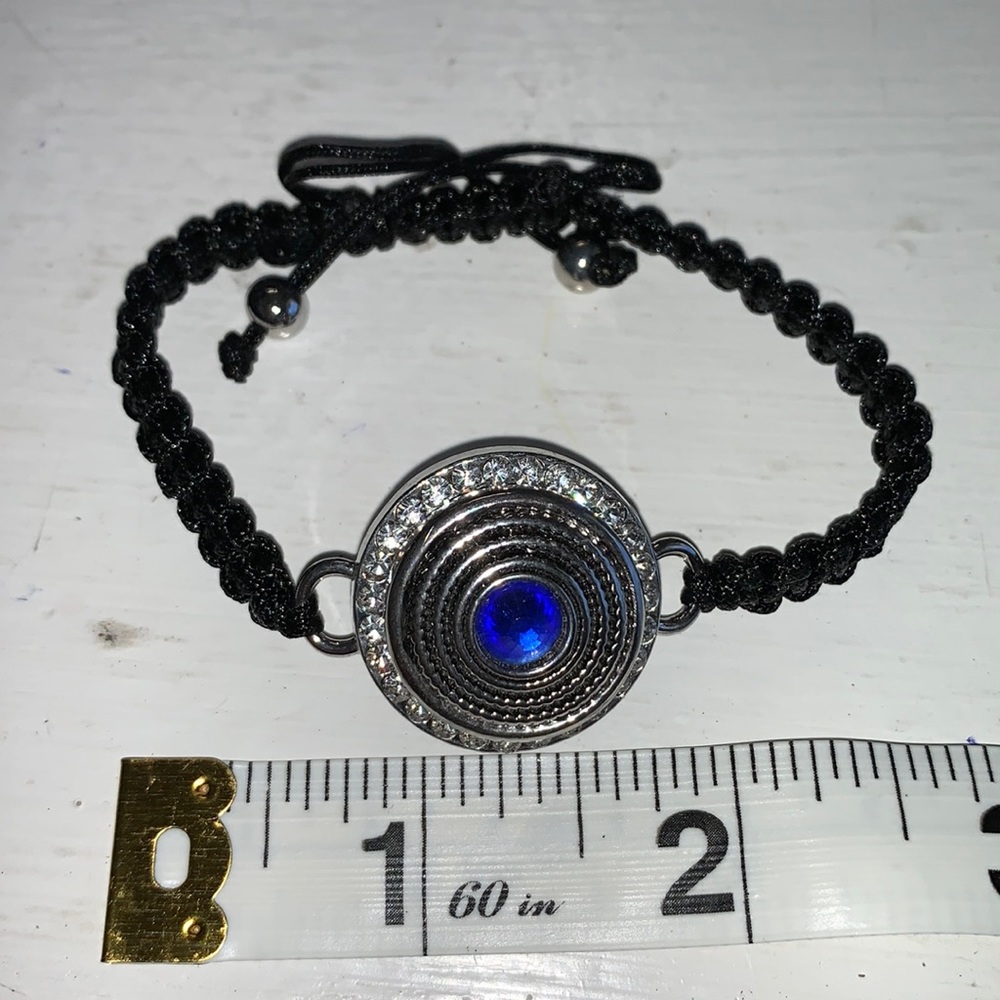 Adjustable braided black cord bracelet with one interchangeable snaps.NWOT